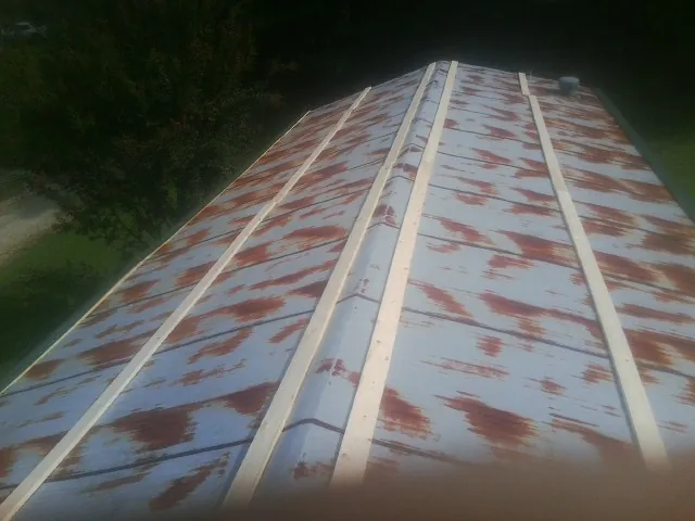 Rusted metal roof panels with new wood purlins before replacement — Storm Damage Roof Repair in Indiana by Roofing Brothers